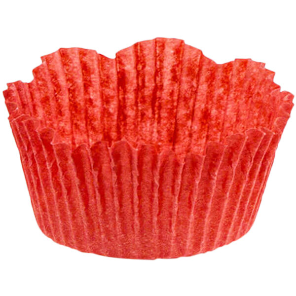 A close-up of a red Novacart fluted baking cup with a petal design.