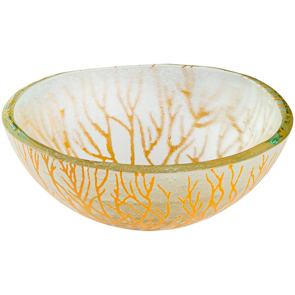 A yellow glass bowl with orange branch designs.