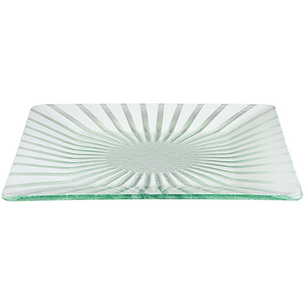 A close-up of a Rosseto Kalderon white glass platter with a sunburst design.