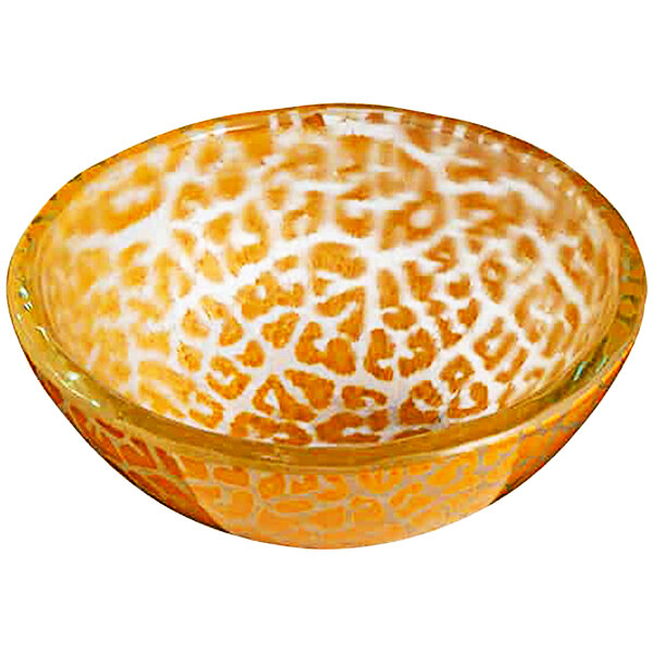 A close up of a round yellow glass bowl with a pattern on it.