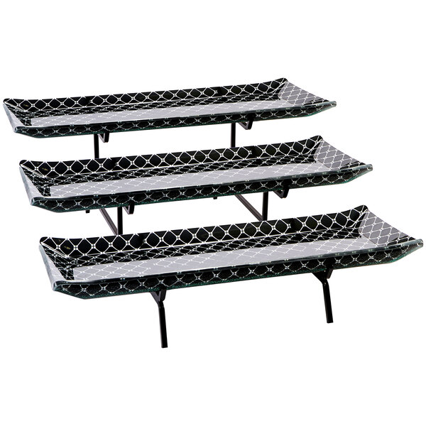 A Rosseto Zenit 3 level display stand with black glass platters on a table.