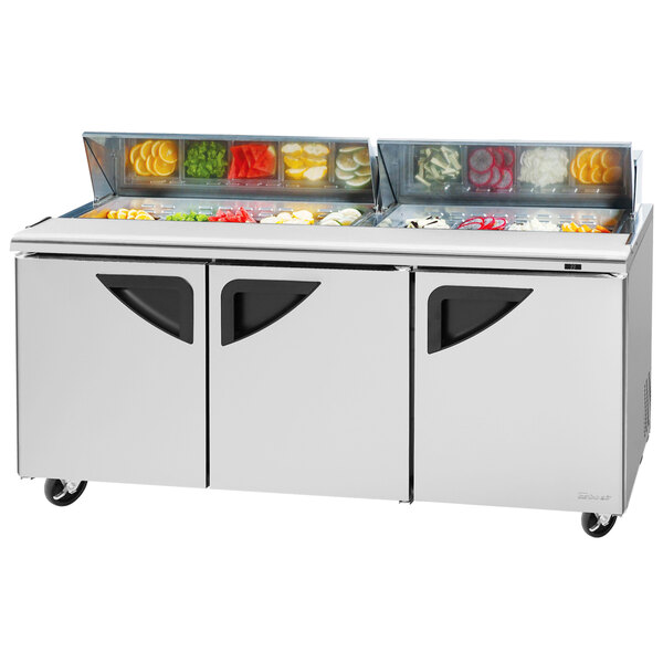 A Turbo Air refrigerated sandwich prep table with three doors and two drawers.