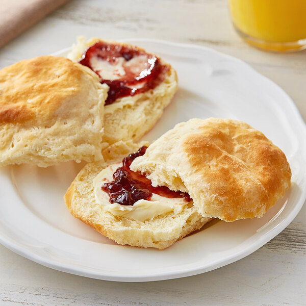 A plate with Pillsbury Southern Style preformed biscuits and jam.