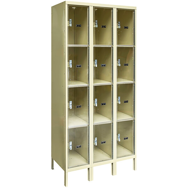 A group of tan metal box lockers with glass doors.