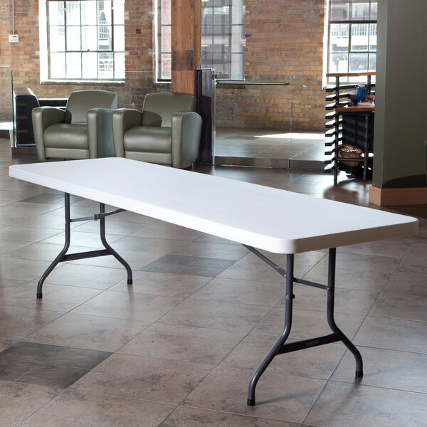 A white Lifetime folding table with a metal frame.