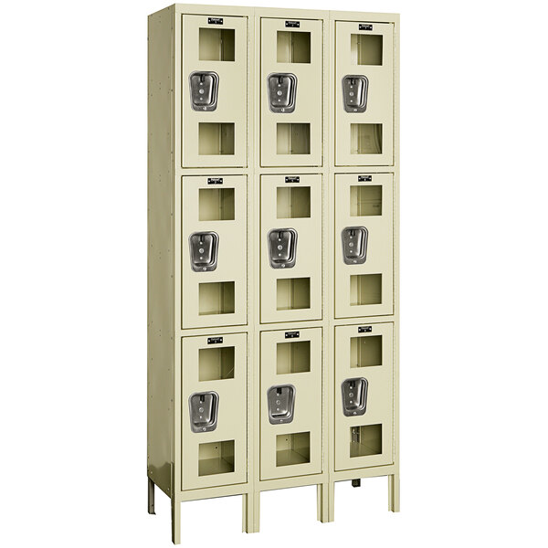 A tan Hallowell triple 3-tier wardrobe locker with silver doors.