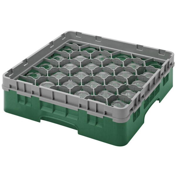 A green and grey plastic Cambro glass rack with round glass inside.
