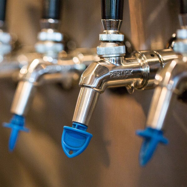 A row of San Jamar beer taps with blue Kleen Plugs.