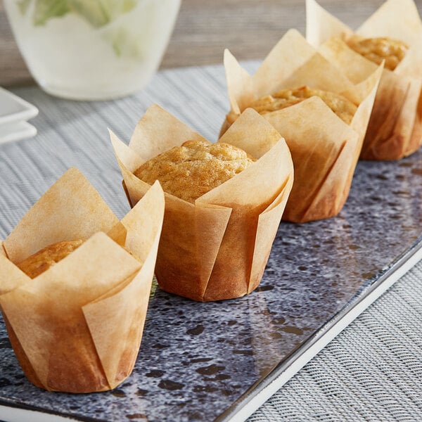 A row of muffins in Baker's Mark mini tulip baking cups on a plate.