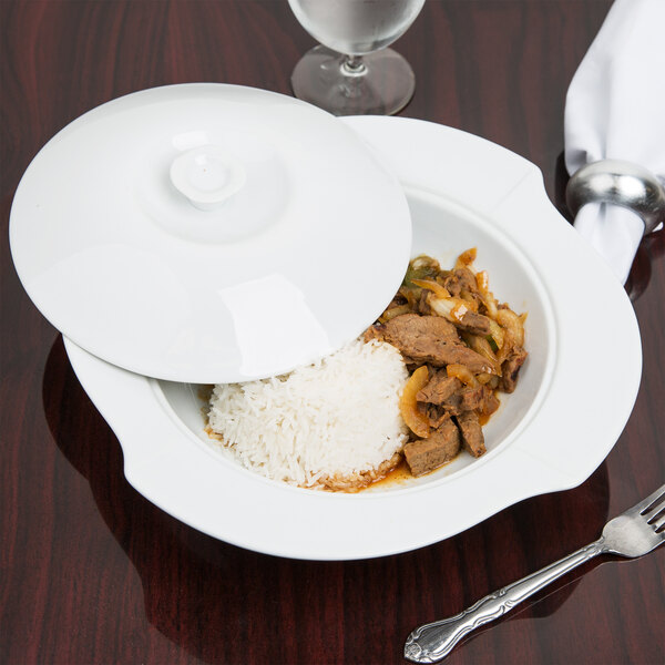 A CAC bright white porcelain pasta serving bowl with a lid filled with food.