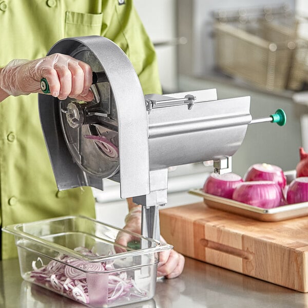A person using a Garde vegetable slicer to cut an onion.