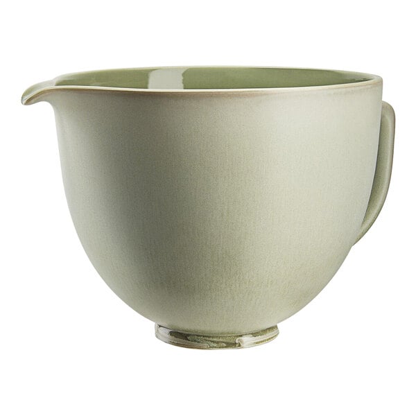 A green KitchenAid ceramic mixing bowl with a handle.