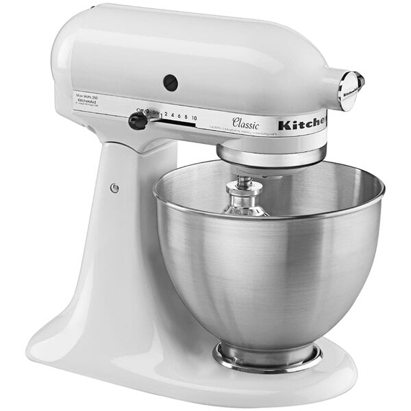 A white KitchenAid tilt head countertop mixer with a bowl.
