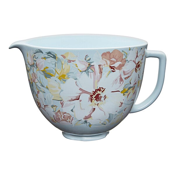 A white ceramic mixing bowl with a floral design.