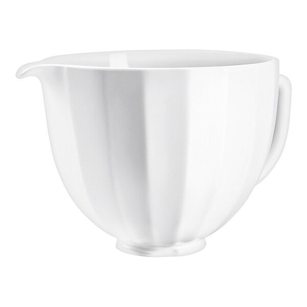 A white KitchenAid ceramic mixing bowl with a curved shell design and handle.