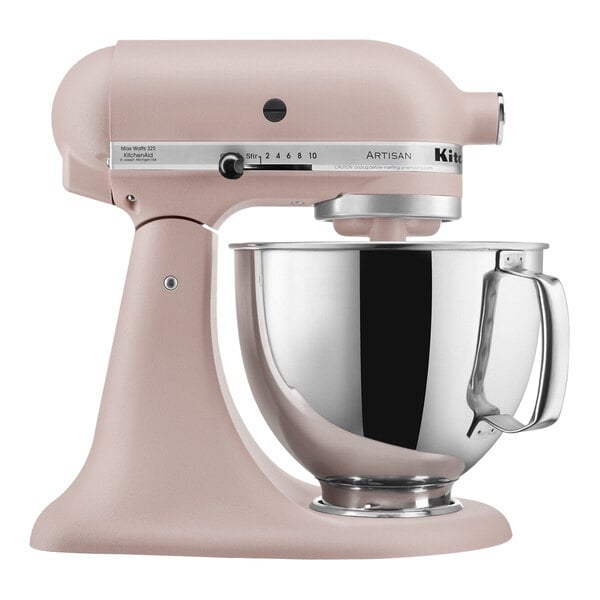 A KitchenAid Artisan stand mixer in pink with a silver bowl.