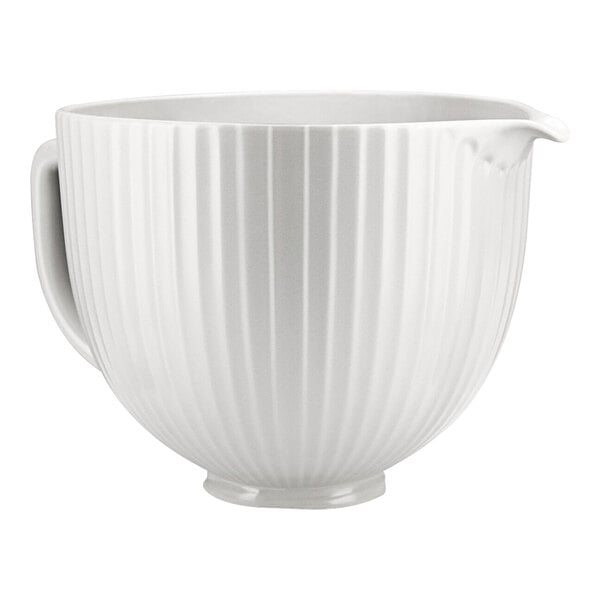 A white KitchenAid ceramic mixing bowl with a handle.
