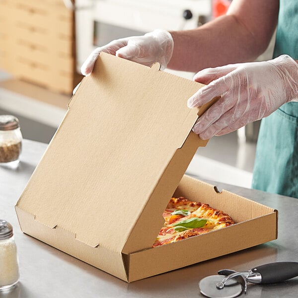 A person in gloves opening a Choice kraft corrugated pizza box.