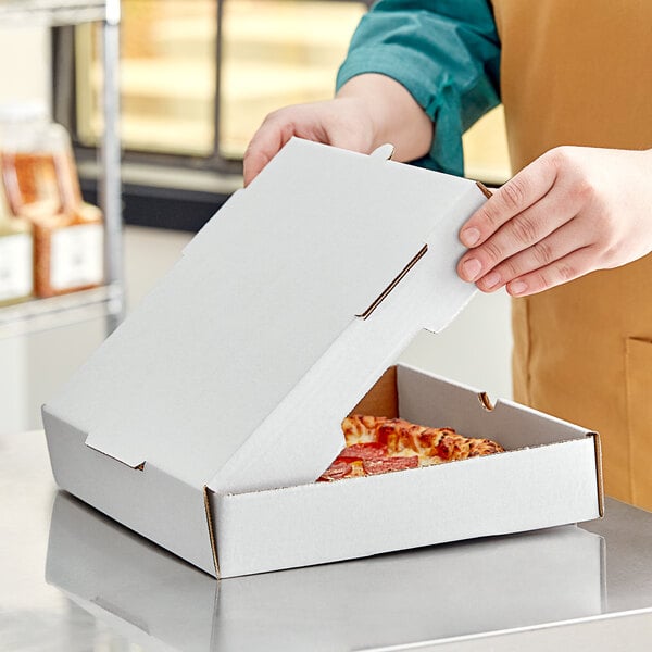 A person opening a white Choice pizza box.