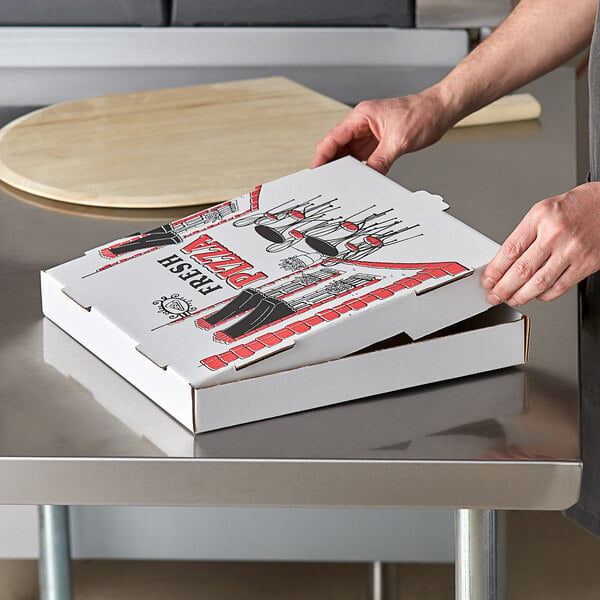 A person opening a Choice white corrugated pizza box on a counter.