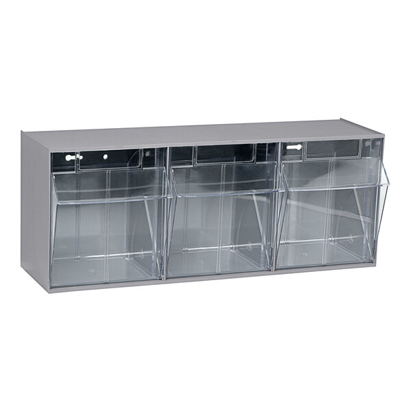 A grey Quantum tip-out storage system with clear plastic bins inside.