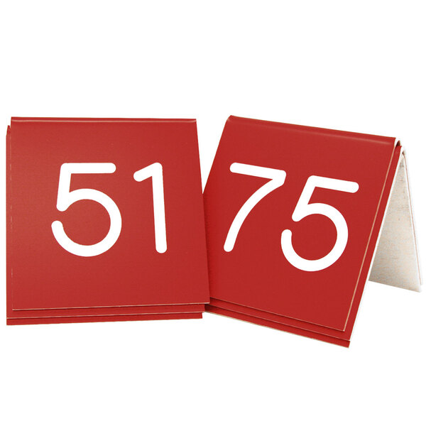 Two red Cal-Mil table tents with white number 55s.