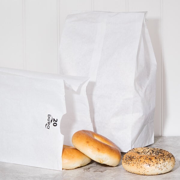 A Duro white paper bag with a bagel inside.