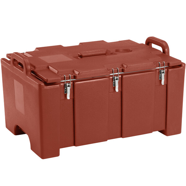 A red plastic Cambro food pan carrier with handles.