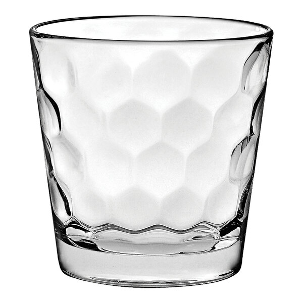 A clear Vidivi rocks glass with hexagons on it.