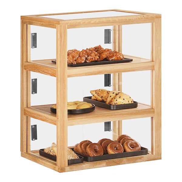A wooden Cal-Mil bakery display case with different types of pastries.