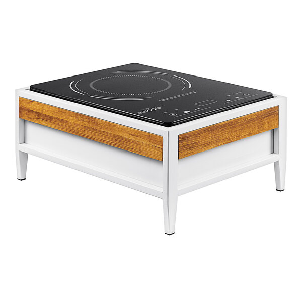 A white and black Cal-Mil Monterey countertop induction range on a wooden table.