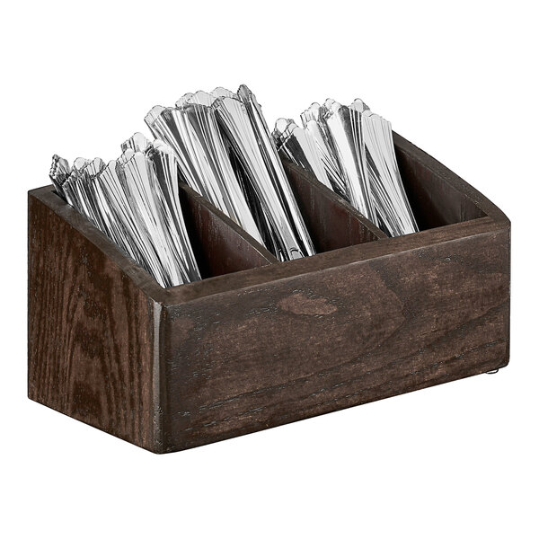 A Cal-Mil dark-stained oak wood flatware organizer with silverware inside.