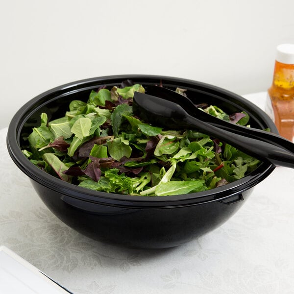 A salad in a Fineline black PET plastic bowl with a spoon.