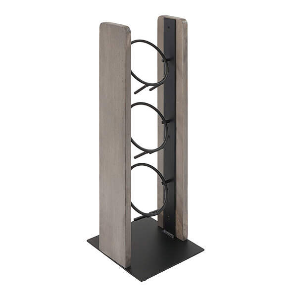 A gray-washed pine wood and metal vertical flatware display with rings for three cylinders.