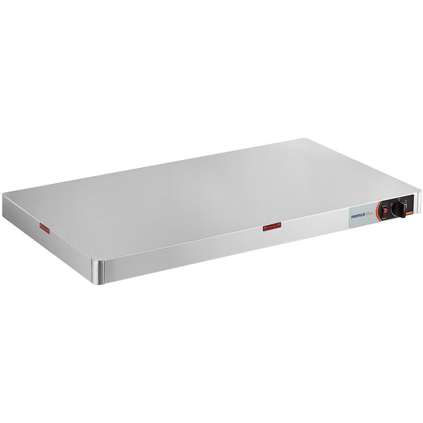 A rectangular white Nemco heated shelf warmer with stainless steel sides and a red label over a black knob.