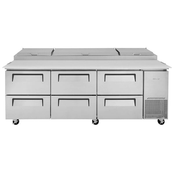 A stainless steel Turbo Air pizza prep table with 6 drawers.