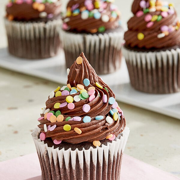 A chocolate cupcake with Pastel Confetti Sequin Sprinkles on top.