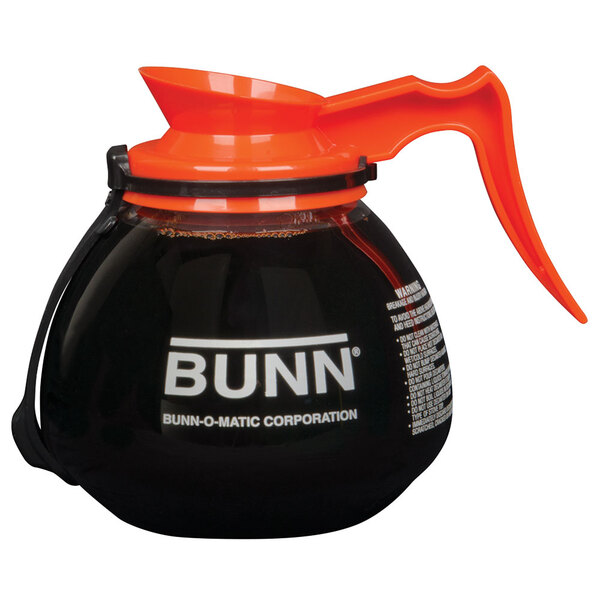 A Bunn glass coffee decanter with an orange handle and lid.