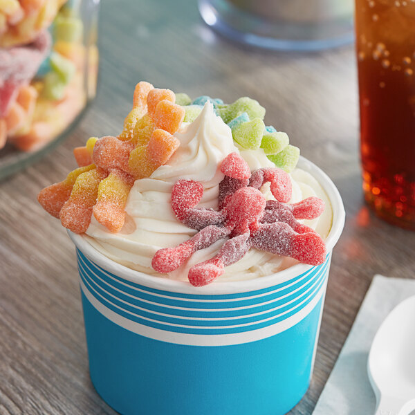 A cup of ice cream with Trolli Sour Brite Gummy Octopus candies on top.