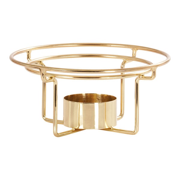 A gold metal bowl with a round base on a table.