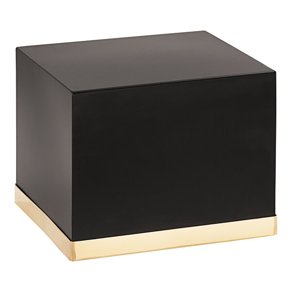 A black square metal display riser with gold trim.