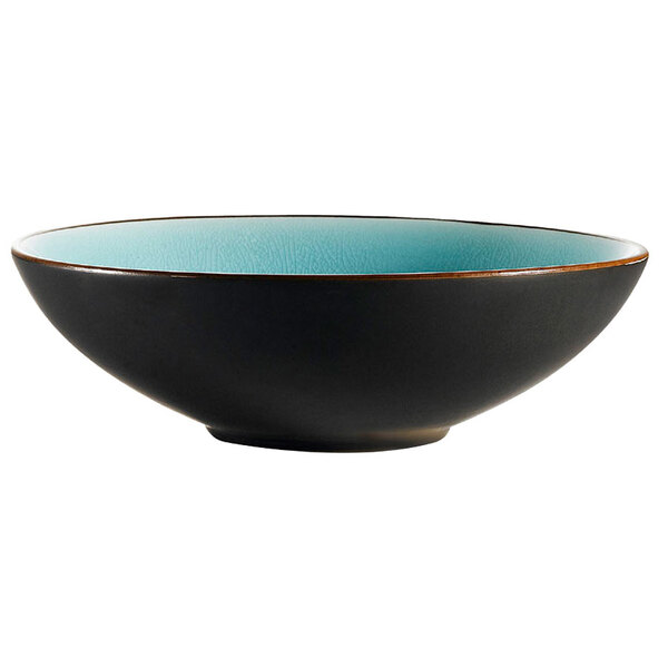 A CAC Japanese Style stoneware bowl with a black exterior and blue rim.