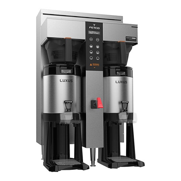 A Fetco CBS-1242 Plus series commercial coffee machine with two coffee makers on top.