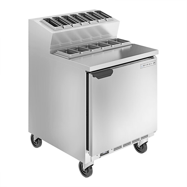 A stainless steel Beverage-Air refrigerated sandwich prep table with rectangular metal pans on top.
