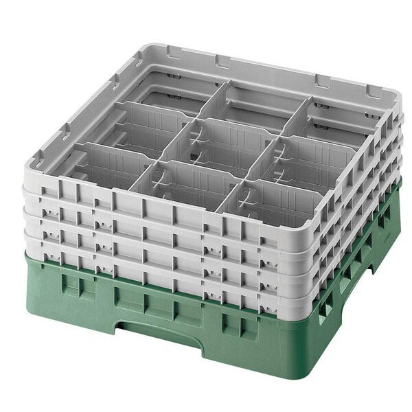 A green plastic Cambro glass rack with 9 compartments and 3 white extenders.