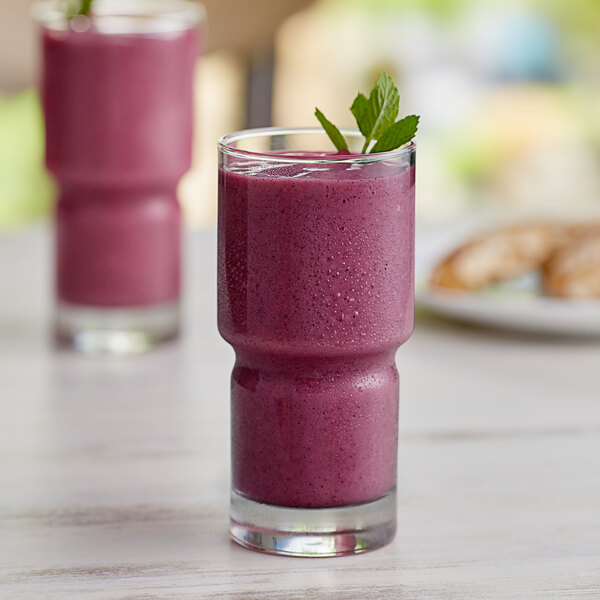 A glass of purple smoothie made with Tropical Acai and Pitaya Dragon Fruit Blender Cubes.
