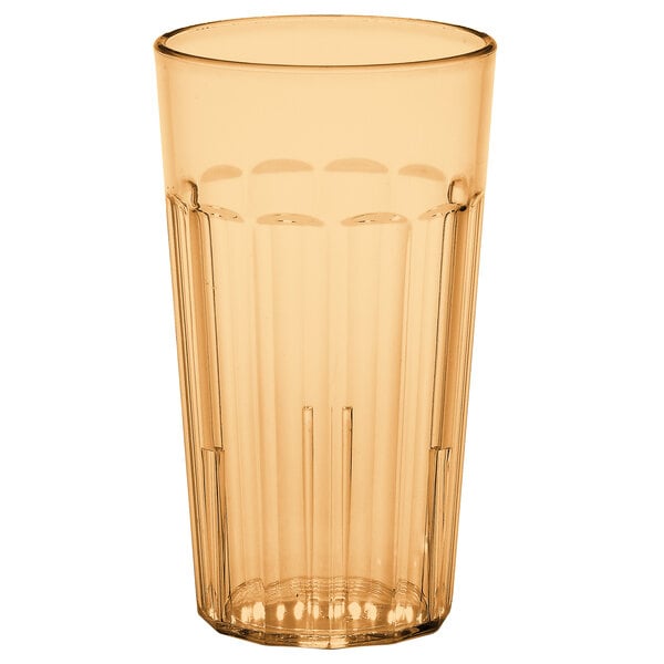 A clear plastic tumbler with an amber rim.