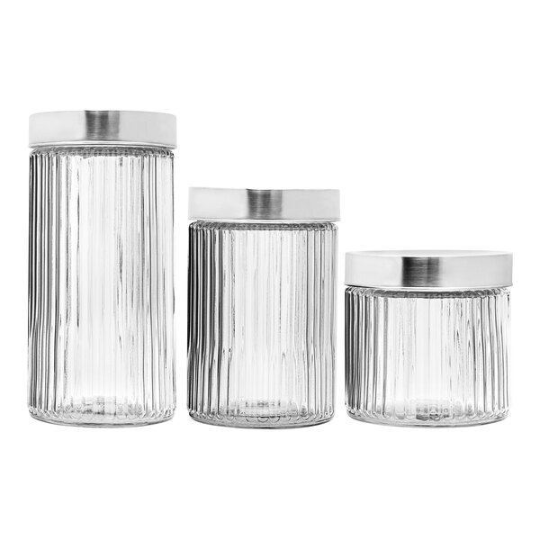 A Stylesetter fluted glass canister set with stainless steel lids.