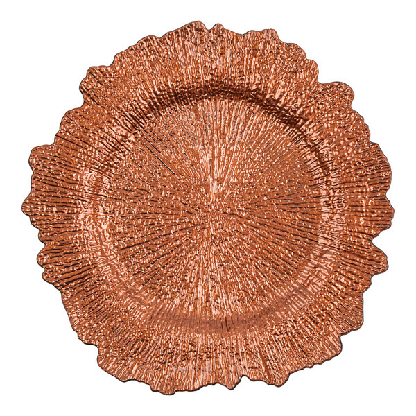 A close up of an American Atelier copper charger plate with a large circular design.