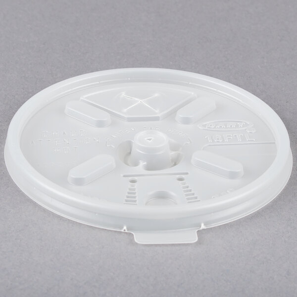 A Dart translucent plastic lid with a straw slot and cross on top.